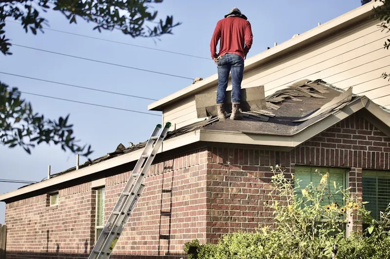 Professional roofer working on a residential roof in Woodlands
